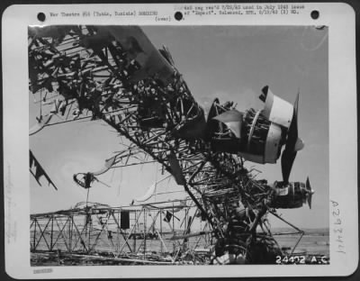 Thumbnail for Consolidated > Tunis, Tunisia-Bones of the ME-323, left at El Aouina Airdrome, show the site and construction of this giant. At the left is a side view, together with remains of two of its six Gnome Rhone 14-cylinder, 850 H.P. twin row radial engines. The length is