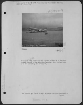 Thumbnail for Consolidated > A Douglas C-53 parked on the flooded runway at an airbase on Adak Island in the Aleutian Islands. Note rubber raft used for unloading the transport.