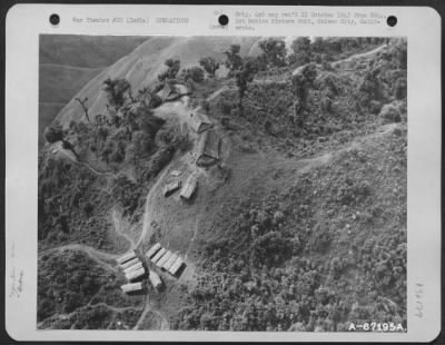 Consolidated > Enroute To The Dropping Zone At The Air Warning Station On Mt. Atwell, The Cargo Plane Flys Low Over A Naga Village.  As The Plane Flew Over The 'Hump', The Crew Members Searched For Any Sign Of Japanese Troops. Burma. August 1943.