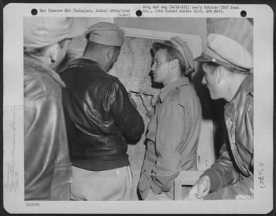 Thumbnail for Consolidated > Colonel Philip Cochran Points Out To Major Sartz The Exact Location Of One Of The Fields In Burma From Which The 1St Air Commando Force Will Operate During The Invasion.  Lalaghat, India.