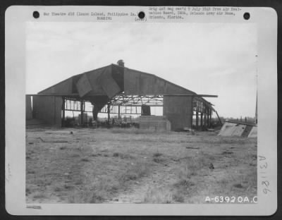 Consolidated > The hangars on the main Clark Air Strip were heavily bombed by units of the American Air Forces. Shown is exterior view of one of the hangars. Luzon Island, Philippine Islands. 1945.