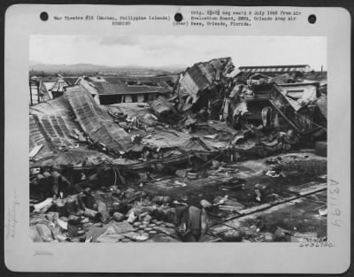 Thumbnail for Consolidated > Bomb damage to refinery building and oil drums at the Philippine Coconut Oil Refinery on Mactan, Philippine Islands, 12 1945.