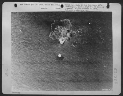 Thumbnail for Consolidated > With an excellent example of precision bombing a B-24 of the Fifth Bomber Command flying at 6,000 feet, puts a 1000 pounder down the hatch of the "concrete battleship," For Drum, in Manil Bay. An integral part of the Manila harbor defense, Fort Drum