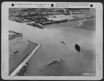 Consolidated > The mouth of the Pasig River, Manila looking SE across Engineer Island. In the inner basin can be seen a coastal passenger cargo ship, 500 G.T. (gross tonnage) two landing stages: a barge and one launch are visible in the bottom half of the