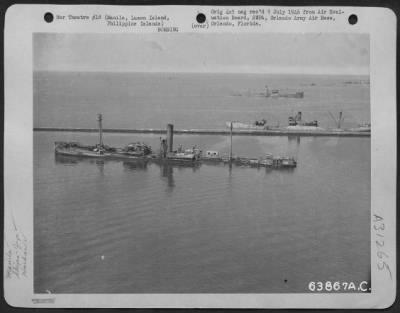 Thumbnail for Consolidated > Manila Harbor. A 5000 g.t. (gross tonnage) sunken Japanese Freighter in foreground; in center, a 4500 g.t. sunken Japanese freighter transport and in the background a 5300 g.t. sunken Japanese freighter. February 1945.