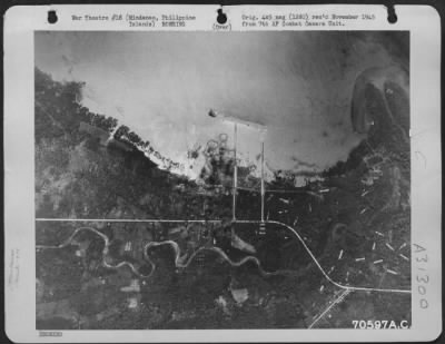 Thumbnail for Consolidated > Bombs, dropped from 494th Bomb Group Consolidated B-24 "Liberators," burst on the target; a Japanese installation south-east of the village of Bunawan on the island of Mindanao in the Philippines. 4 April 1945.