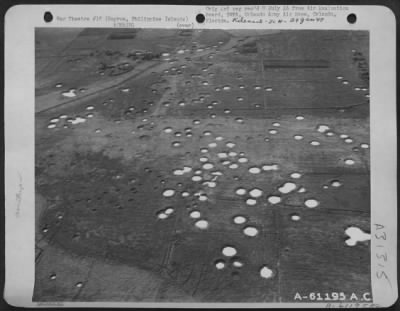 Consolidated > Bomb spattered Malago Airstrip on the west coast of Negros Island, Philippine Islands. This strip was made non-operational by earlier air strikes. 14 May 1945.