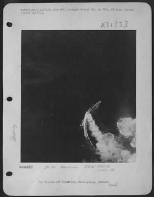 Thumbnail for Consolidated > Burning from direct thousand-pound bomb hits, a Japanese cruiser of the Kuma class circles in a desperate effort to evade new blows by a "Bomber Baron" Liberator formation of the 13th AAF, which attacked it in the Sulu Sea Oct 26, 1944. Left burning