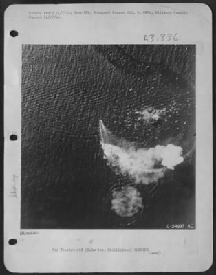 Consolidated > Burning from direct thousand-pound bomb hits, a Japanese cruiser of the Kuma class circles in a desperate effort to evade new blows by a "Bomber Baron" Liberator formation of the 13th AAF, which attacked it in the Sulu Sea Oct 26, 1944. Left burning