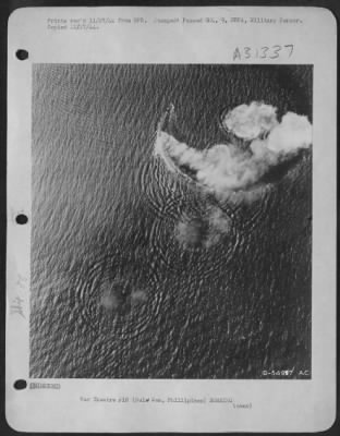 Thumbnail for Consolidated > Burning from direct thousand-pound bomb hits, a Japanese cruiser of the Kuma class circles in a desperate effort to evade new blows by a "Bomber Baron" Liberator formation of the 13th AAF, which attacked it in the Sulu Sea Oct 26, 1944. Left burning