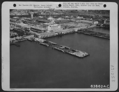 Thumbnail for Consolidated > Piers #3 And #5, Of The Manila Harbor Looking Se. The Damage To These Piers Was Effectewd By The Japanese Demolition. In The Upper Left Of The Photograph, The Walled City Is Visible, February 1945.