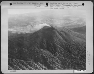 Thumbnail for Consolidated > Mt. Langila, a semi-active volcano on New Britain, smoking as American Bombers flew over to blast the beach just before Maj. Gen. Repertus' marines landed.