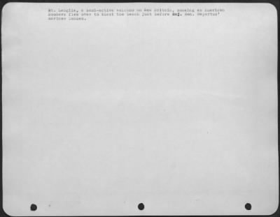 Consolidated > Mt. Langila, a semi-active volcano on New Britain, smoking as American Bombers flew over to blast the beach just before Maj. Gen. Repertus' marines landed.