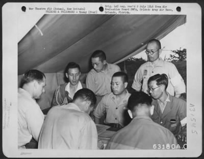 Thumbnail for Consolidated > Col. Lancaster and Lt. Col. Jenkins questioning a Japanese Navy and Army Officer in the position of a Jap Anti-Aircraft group in Rabaul, New Britain. 31 October 1945.