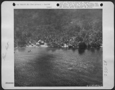 Thumbnail for Consolidated > First picture of the marooned airmen and the Australian was made from a U.S. Army Air Forces heavy bomber. The men may be seen waving excitedly at the prospect of being rescued from the camp they had set up on the beach and where they were building