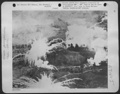 Thumbnail for Consolidated > Incendiary white phosphorus bombs dropped by the USAAF bursts and spread their sticky, flaming "tentacles" out to encompass and burn a Japanese radio station at Rabaul, New Britain.