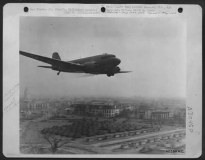 Thumbnail for Consolidated > Douglas C-47 with special Venturi attachment spraying DDT over camp area in Manila, Philippine Islands.