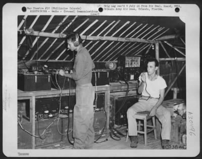 Consolidated > GCA (Ground Control Approach) controllers operating Air-Ground radios installed in a tent and remoted from the operations van of the SCR-527-A radar station. 45th Fighter Sector, Alaminos, Luzon in the Philippine Islands. (This is radio equipment