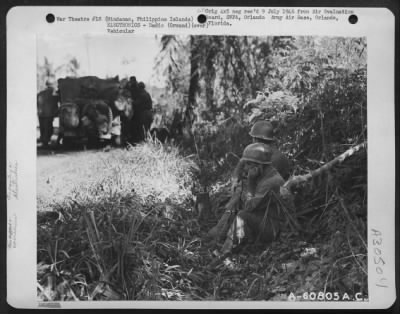 Consolidated > While the JASCO jeep is making contact with a flight of planes through Air Support Party, the mortar company radio control personnel made arrangements for marking the target. The walkie-talkie radio connects them with the mortar company that will