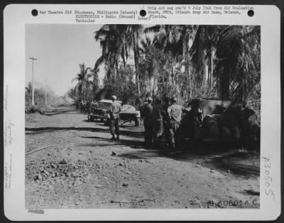 Consolidated > The JASCO jeep has now contacted the flight of planes and awaits their approach. Up the road, the mortar company has laid a smoke screen of bright orange color marking the position of front line Allied troops. The 13th Air Force requires that all air