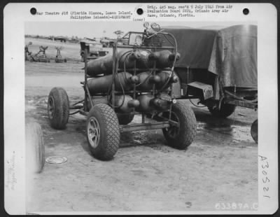 Thumbnail for Consolidated > Mounted on pneumatic tires that easily traverse rough ground, the oxygen trailer can be towed either by jeep, tug, or truck to the airplane being maintained on the flight line. Florida Blanca, Luzon Island, August 1945.