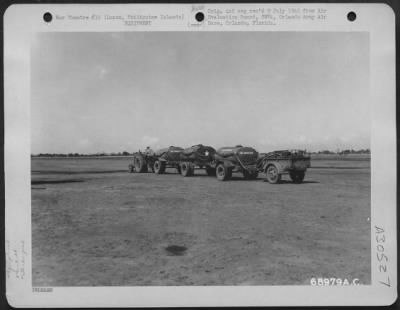 Consolidated > Emergency fuel tanks of the 64th Air Service Group are towed out to the line at the Lacag Air Strip on Luzon, Philippine Islands. 20 May 1945.