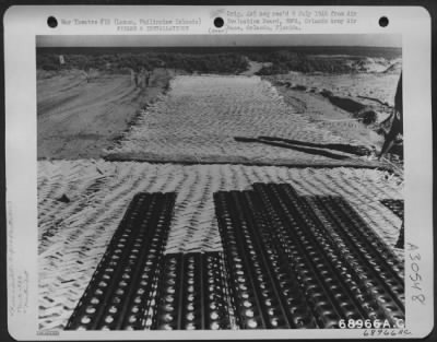 Thumbnail for Consolidated > Bamboo mat is placed under the steel planks at the hardstand under construction on Lingayen Strip, Luzon, Philippine Islands. The work is done by natives and men of the 836th Engineer Aviation Battalion.