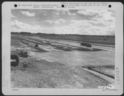 Thumbnail for Consolidated > As a truck spreads gravel and stone on Bacolod Strip, Negros, Philippine Islands, a roller followed it up to smooth and flatten the surface of the runway. 1 June 1945.