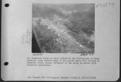 Consolidated > When large para-packs full of supplies, dropped on Randolph Field on Leyte Island in the Philippines, they made large holes in the strip, so the Engineers stands by to fill in the holes as soon as the pack is carried away.