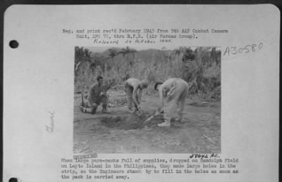 Thumbnail for Consolidated > When large para-packs full of supplies, dropped on Randolph Field on Leyte Island in the Philippines, they made large holes in the strip, so the Engineers stands by to fill in the holes as soon as the pack is carried away.