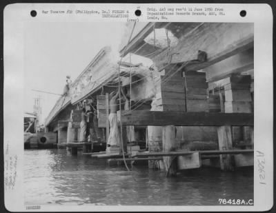 Thumbnail for Consolidated > Men of the 1876th Eng. Aviation Battalion at work repairing a bomb damaged bridge somewhere in the Philippine Islands. 25 June 1945.