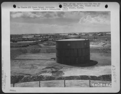 Thumbnail for Consolidated > Gasoline bulk plant near Neilson Field, Luzon Island, Philippine Islands. These are temporary tanks; the first is a 10,000 gallon, the second a 5,000 gallon, and the third a 10,000 gallon tank. Note the pipeline leading in and out of the tanks.