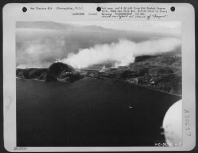 Consolidated > View of San Jose prior to amphibious landing, Heavy shelling from naval vessels on both sides of Corregidor. Barges are coming in under smoke in this picture.