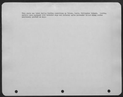 Thumbnail for Consolidated > This photo was taken during landing operations on Tolosa, Leyte, Philippine Islands. Landing parties were equipped with invasion maps and infantry units proceeded inland along routes previously plotted on maps.