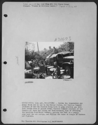 Consolidated > HEADQUARTERS, 13TH AAF, PHILIPPINES--Unlike the tremoundous gas pumps which are in use in the United States, Air Service Command soldiers of the 6th Service Group have to pump aviation gas into fuel trucks from 50 gallon drums. Service Command