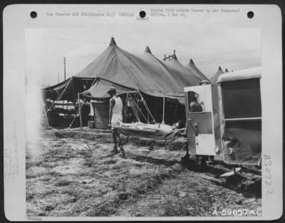 Thumbnail for Consolidated > Nielson Field, Manila, Philippine Islands, 11 May 1945. Co. "C," 264th Medical Bn. "Holding Company." Here a patient evacuated from a forward area in a Vultee L-5, is being removed to an ambulance to take him to the "Holding Company" Area. One L-5