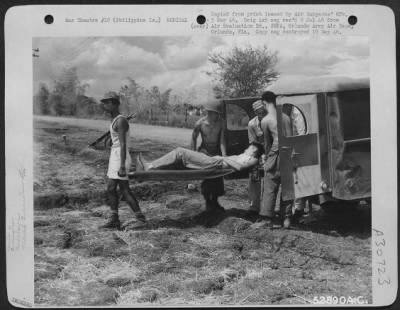 Thumbnail for Consolidated > Nielson Field, Manila, 11 May 1945. Co. "C," 264th Medical Bn.-Unloading patient at receiving tent of the Holding Company. This patient was evacuated from a forward area by air in a Vultee L-5.