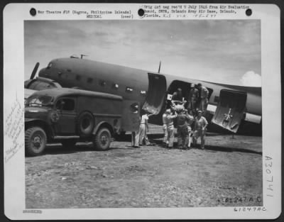 Thumbnail for Consolidated > An ambulance of the 37th Field Hospital brought this patient to the waiting Douglas C-47 "Skytrain," 65th Troop Carrier Squadron, for evacuation to a Leyte General Hospital. This soldier was wounded fighting in the hill positions of Negros