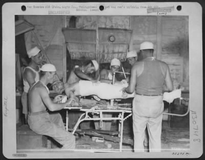 Thumbnail for Consolidated > An American soldier, wounded by Japs, is given emergency treatment by medics in hospital that was once Palo, Leyte Academy, Philippine Is.