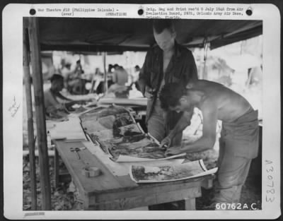 Consolidated > Mosaics in one phase of assembly by 31st Division Photo Intelligence Section in the Philippine Islands. Maps in this area were inadequate and erroneous; so aerial mosaics were used by advance units whenever possible.