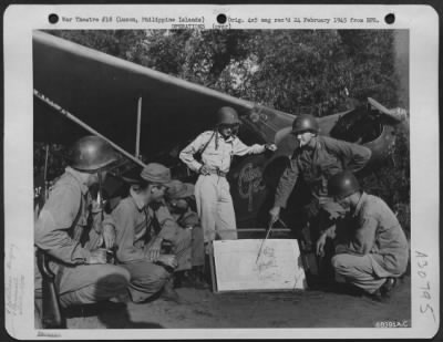 Thumbnail for Consolidated > At the first crack of dawn, Major James A. Williams of Ontario, California, briefs pilots of Piper L-4's who serve as observers for the 40th Division during the fierce battle to recapture Clark Field, Luzon, Philippine Islands. They are left to right