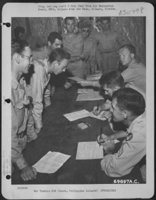 Thumbnail for Consolidated > In the classification building of the 22nd Replacement Depot, processing personnel check records of combat troops who are en route to the United States. Manila, Luzon, Philippine Islands, July 1945.