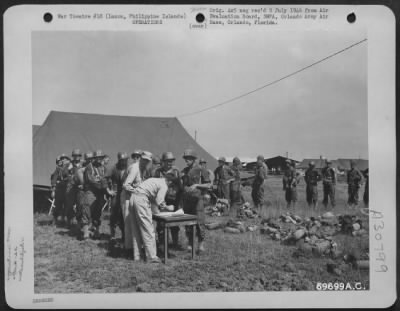 Thumbnail for Consolidated > Upon arrival at the 22nd Replacement Depot, the names of the individuals, en route to the United States, are checked against the shipping list order. Manila, Luzon, Philippine Islands. July 1945.