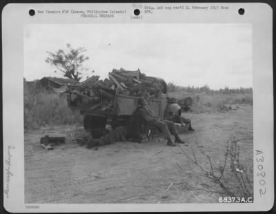 Thumbnail for Consolidated > Exhausted after hours of hard fighting on the hills overlooking Clark Field, Luzon, Philippine Islands, "GI's" snatch the opportunity to rest against a knocked-out Jap truck. Sleep came at irregular hours and the gruelling work of a foot soldier took