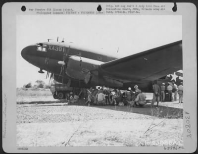 Thumbnail for Consolidated > First internees from St. Thomas wait eagerly to be evacuated by air from Quezon Airstrip in the "Curtiss Commando" C-46. Luzon Island, Philippine Islands, 1945.