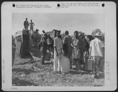 Consolidated > Released prisoners debark from an amtrack at Laguna De Bay after their liberation from the Los Banos Prisoners of War Camp in Manila, Luzon, Philippine Islands.