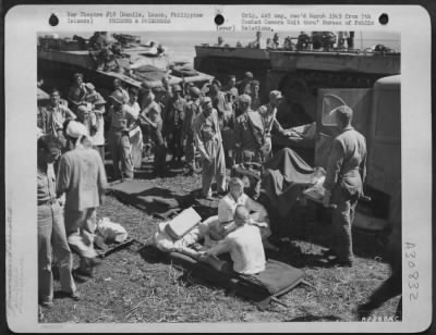 Thumbnail for Consolidated > Internees wounded in the taking of a prison camp at Manila, Luzon, Philippine Islands, are loaded on stretchers prior to being placed in waiting ambulances.