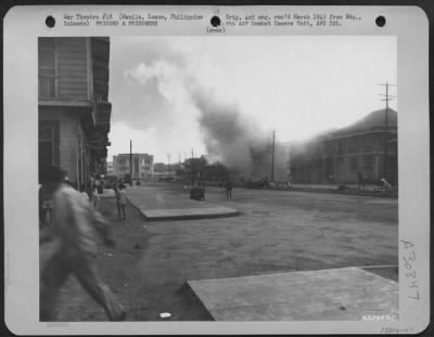 Thumbnail for Consolidated > During an intense shelling by the Japanese of the Prison Compound at Santo Tomas, Manila, Philippine Islands, an adjacent building was hit and the entire block burned to the ground. The Japanese used the flames for observation and continued their