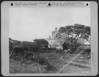 Thumbnail for Consolidated > The main building of the Prison Compound at Santo Tomas, Manila, Philippine Islands, is shown as it is hit by a barrage of high calibre guns fired by firmly entrenched Japanese in the down-town Manila sector. The reign of terror inflicted on the