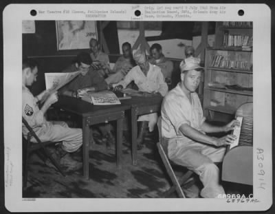 Thumbnail for Consolidated > Enlisted men take advantage of the facilities provided for their entertainment in the Special Services Room of the Manila Leave Center, located on the banks of the Pasig River in Manila, Luzon, Philippine Islands. 28 August 1945.